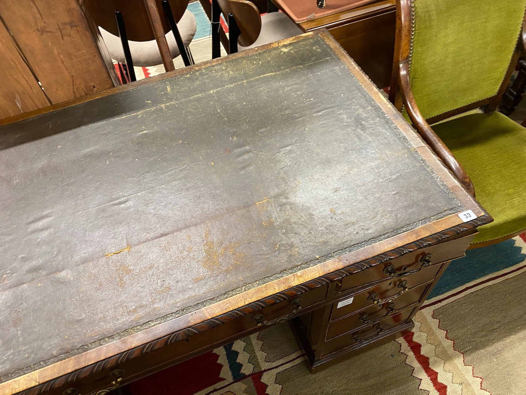 An early 20th century Chippendale revival mahogany pedestal desk, requiring restoration, length 135cm, depth 79cm, height 73cm